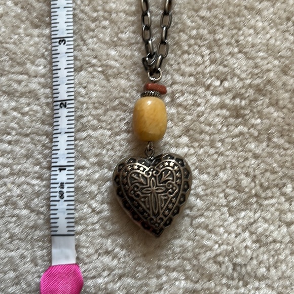 Pewter toned heart necklace. Appears to be a cross on heart - Picture 2 of 3